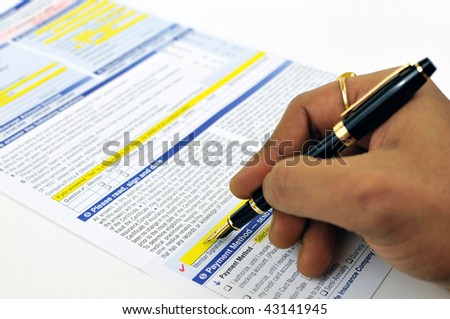 Man signing life insurance application form using a fountain pen