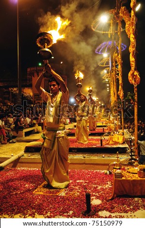 VARANASI, INDIA - APRIL 1: Unidentified Hindu priests perform the fire ritual during religious Ganga Aarti festival on April 1, 2011 at Varanasi, Uttar Pradesh, Central India.