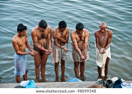 VARANASI, INDIA - FEBRUARY 18: Unidentified Hindu pilgrims offer prayers on the bank of holy Ganges river on the auspicious Maha Shivaratri festival on February 18, 2011 at Varanasi, Uttar Pradesh, India.