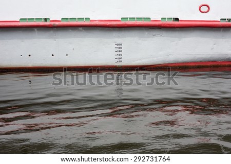 Detail of side of the ship is reflected in the water, creating an abstract image