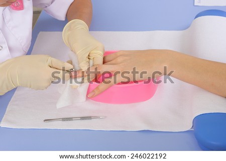 step of manicure process: nails and cuticles shaping with manicure tools