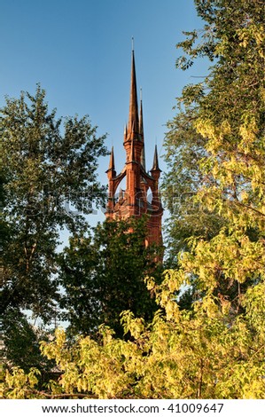 fairy tale, castle like catholic church with trees in foreground and sky in background