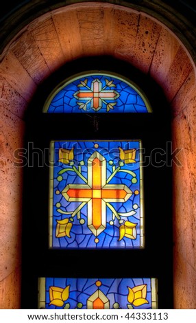 colorful mosaic church window  lighted from behind