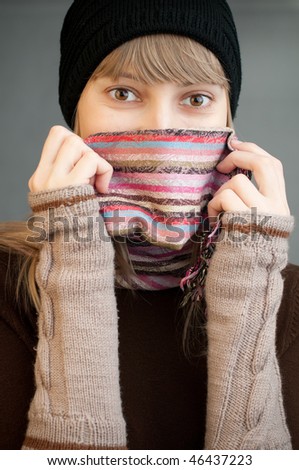 beautiful young woman in winter clothes smiling at the camera
