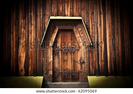 old beautiful magic wooden gate with ornate iron lock
