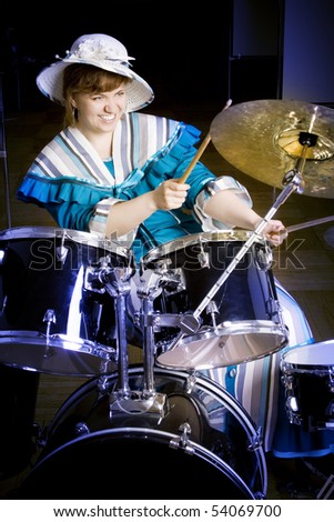 The young woman plays drums