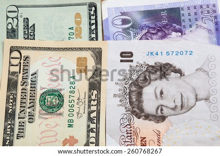 United States Ten and Twenty Dollar notes next to Ten and Twenty UK Pound Notes