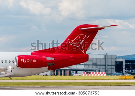 MANCHESTER, UNITED KINGDOM - AUG 07, 2015: Denim Air Fokker F100 tail livery at Manchester Airport Aug 07 2015.