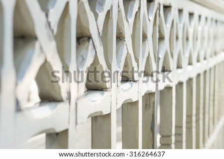 old wrought wood railings on balcony blurred