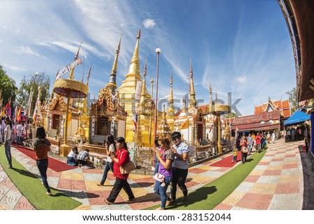 PHRA BOROMMATHAT TEMPLE, TAK PROVINCE, THAILAND 31 MAY 2015 : Buddhist people praying and walking around a golden pagoda in \