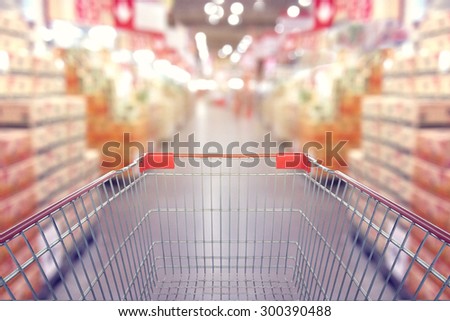 View from shopping cart trolley basket at supermarket self-service grocery shop. Retail. Blurred background, Vintage filter
