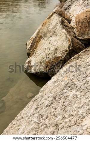 Boulders on the shore of the Blue Hole at Dinosaur Valley State Park Texas
