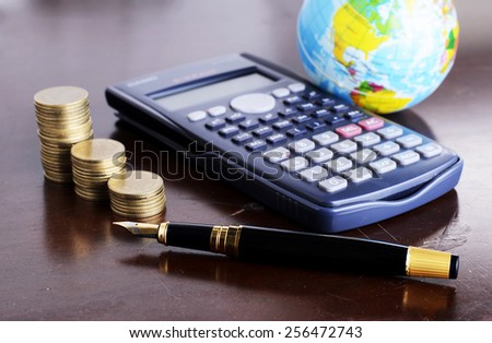 Calculator money coins with fountain pen and earth for loan money concept