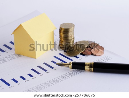 House paper and coins stack and Fountain pen for Home loans concept
