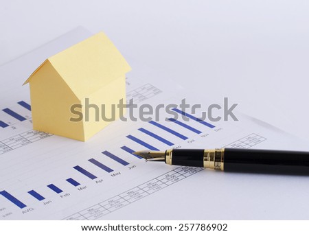 Close up of Fountain pen and house paper on chart for loan money concept