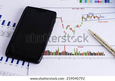 stock trade with mobile phone and pen for Finance concept
