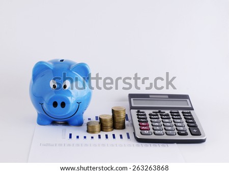 Blue piggy bank and calculator money coins for loans concept