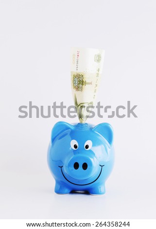China banknote into piggy bank for saving money concept