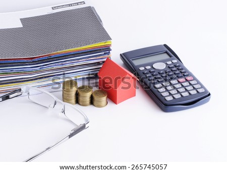 Loans concept with close up for house paper and coins stack and calculator and Eyeglasses and bill payment