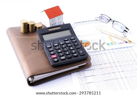 Mortgage loans concept with calculator and money coins stack and