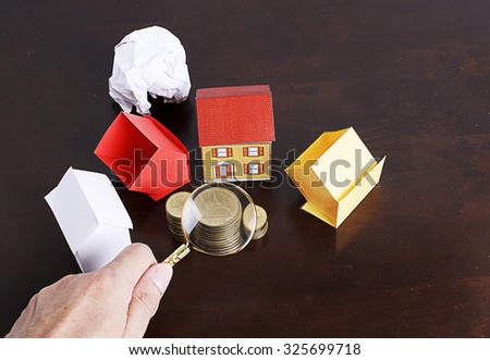 Mortgage loans concept with paper house and coins stack