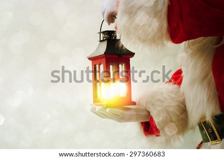 Santa Claus holding  vintage lantern