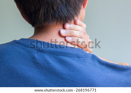 Asian man having neck pain and feeling bad