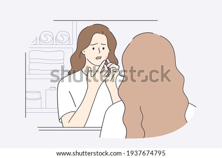 Skincare, skin problems, pimples concept. Beautiful girl in white t-shirt cartoon character squeezing pimples on her face while looking into mirror in bathroom feeling unhappy vector illustration 