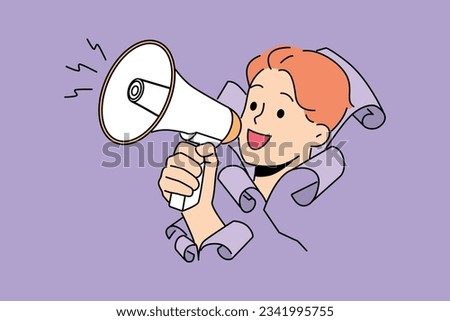 Man shouts into megaphone, sticking head out of hole in paper and calling for attention to advertising campaign. Guy with megaphone in hand symbolizes activism in order to draw attention to problems
