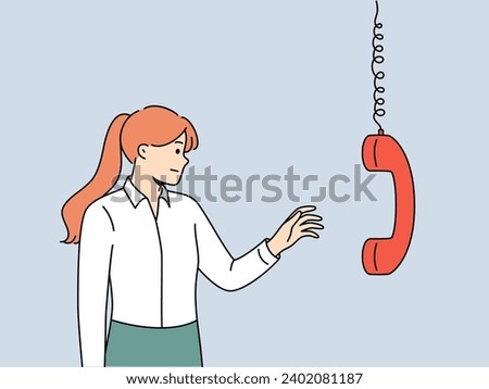 Business woman reaches out to telephone receiver to talk with company partners. Girl manager with dissatisfaction is about to answer call from boss demanding improvement in business performance. 