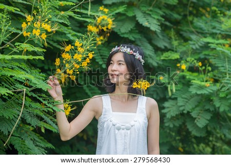 fashion beautiful Asian woman flower crown in garden Thailand