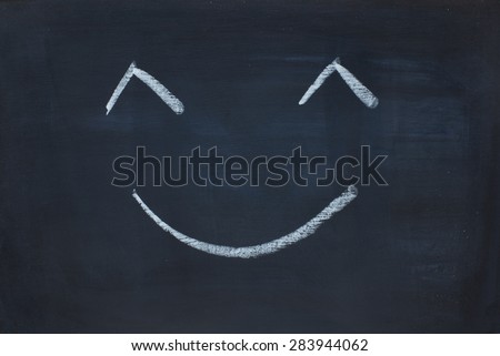 emotion happy face on black chalk board
