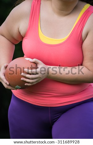 fat woman play rugby ball