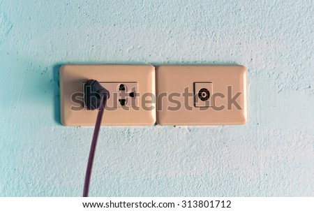Electrical outlet with black power cord. Home interior electrical outlet with black power cord