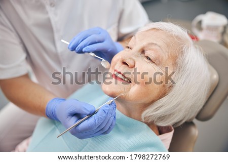 Close up portrait of elderly beautiful woman check up and having the consultation with dentist at the dental office Foto d'archivio © 