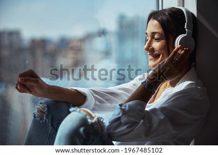 Similar – Image, Stock Photo Cheerful woman listening to music in headphones