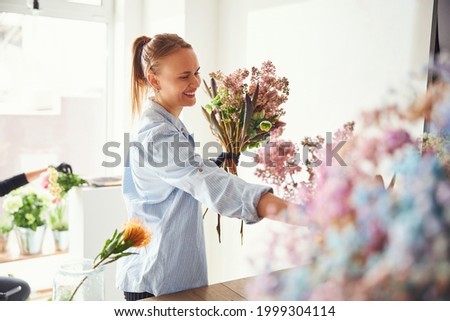 Similar – Image, Stock Photo Female designer creating floral bouquets in studio