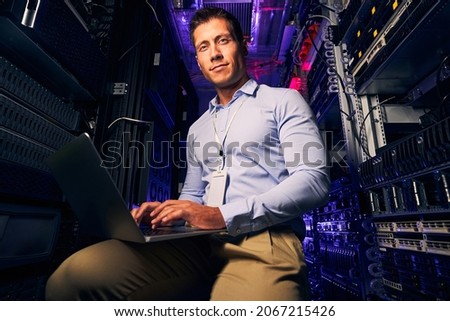 Tranquil system administrator working in server room Foto stock © 