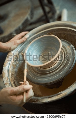 Similar – Image, Stock Photo Female ceramist making clay bowl in studio