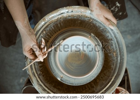 Image, Stock Photo Female ceramist making clay bowl in studio