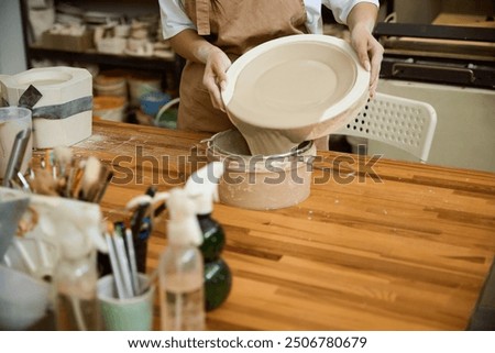 Similar – Image, Stock Photo Crop woman sculpturing pot with clay