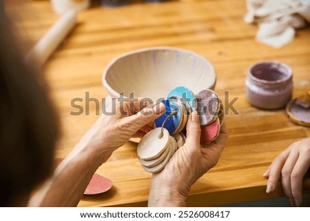 Similar – Image, Stock Photo Craftswoman painting a bowl made of clay in art studio