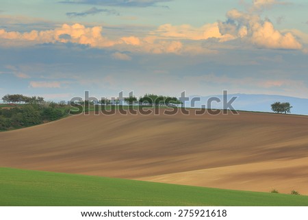 Rolling hills with fields in sunset light suitable for backgrounds or wallpapers.Southern Moravia, Czech republic.
