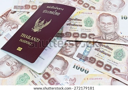 Thailand passport with Thai money ready to travel on white background