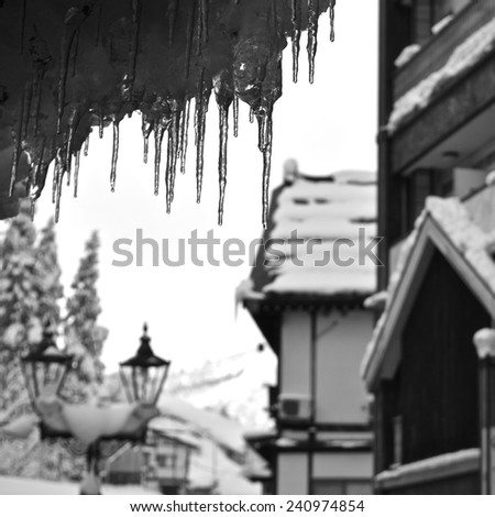 icicles in a snowy village, black and white