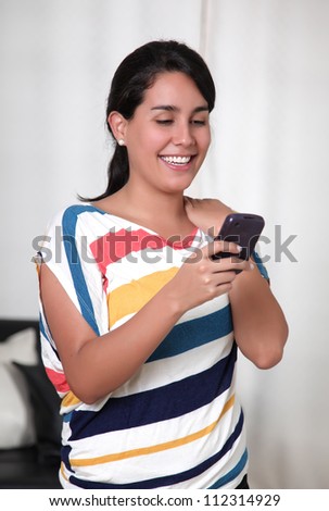 woman getting a call on his cell phone with a smile