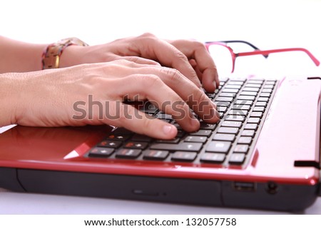hands typing a red notebook a sign of labor and technology