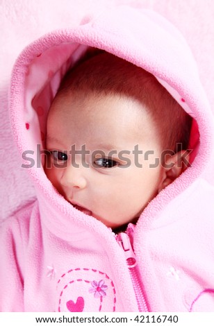 Beauty baby on pink hood, Head and shoulders portrait
