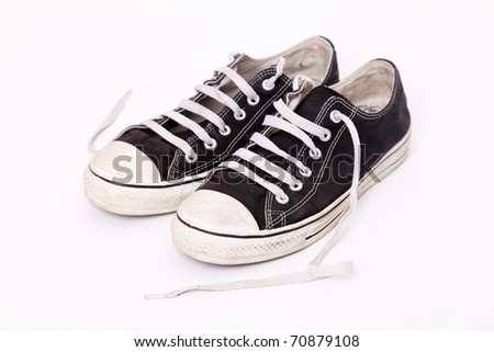 Pair Of Shoes Worn With The Laces Loose Over White Background Stock ...