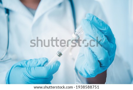 Doctor with syringe ready for injection of vaccine to patient. Vaccination concept.	